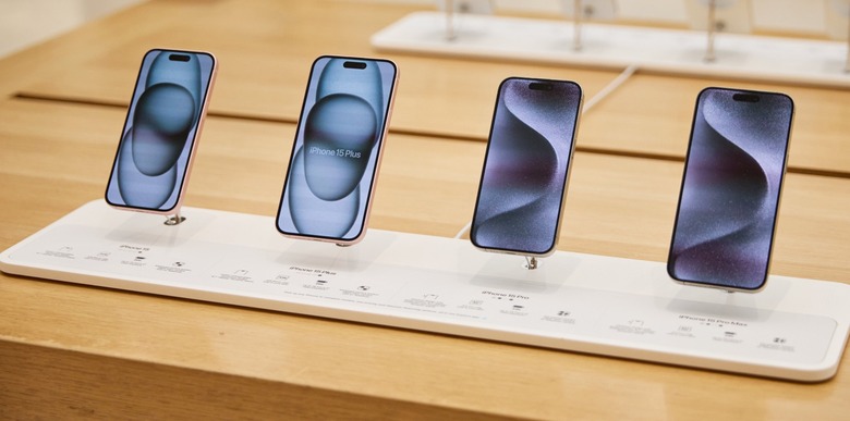 iPhone 15 models in an Apple retail store.