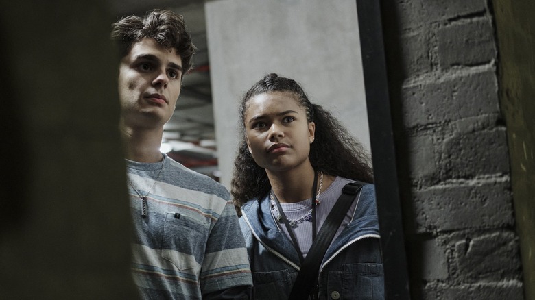 (L to R) CONNOR GOSSATI as SIMON, TAMARA SMART as YOUNG JADE, CONNOR GOSSATI as SIMON in RESIDENT EVIL.