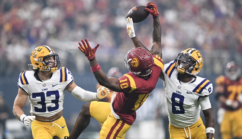 Kyron Hudson #10 of the USC Trojans makes a catch against West Weeks #33 and Major Burns #8 of the LSU Tigers in the second quarter of the Vegas Kickoff Classic at Allegiant Stadium on September 01, 2024 in Las Vegas, Nevada.