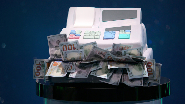 cash register with money overflowing