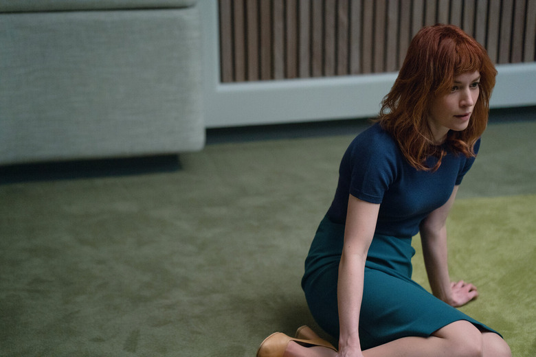 a young woman sitting on the floor