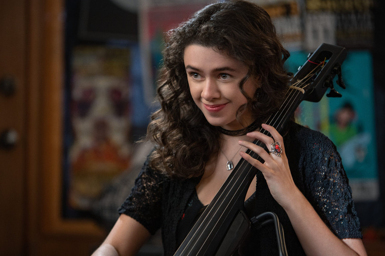 closeup of a young woman holding a musical instrument