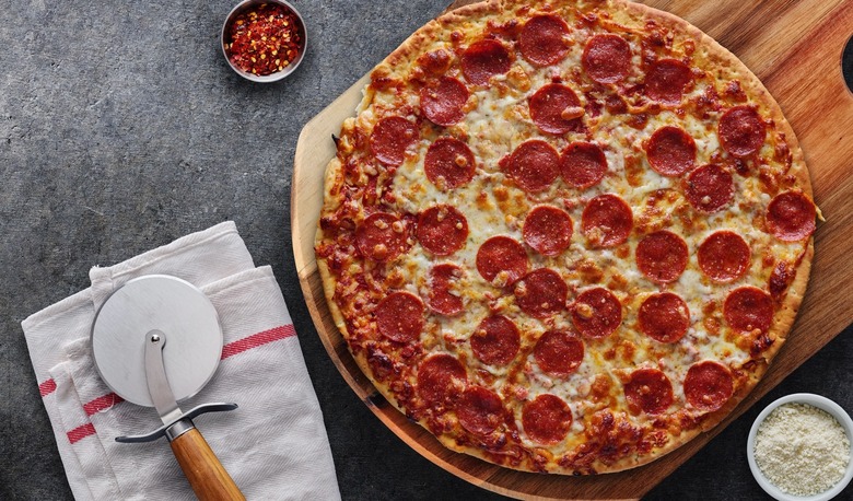 A pepperoni pizza on a counter