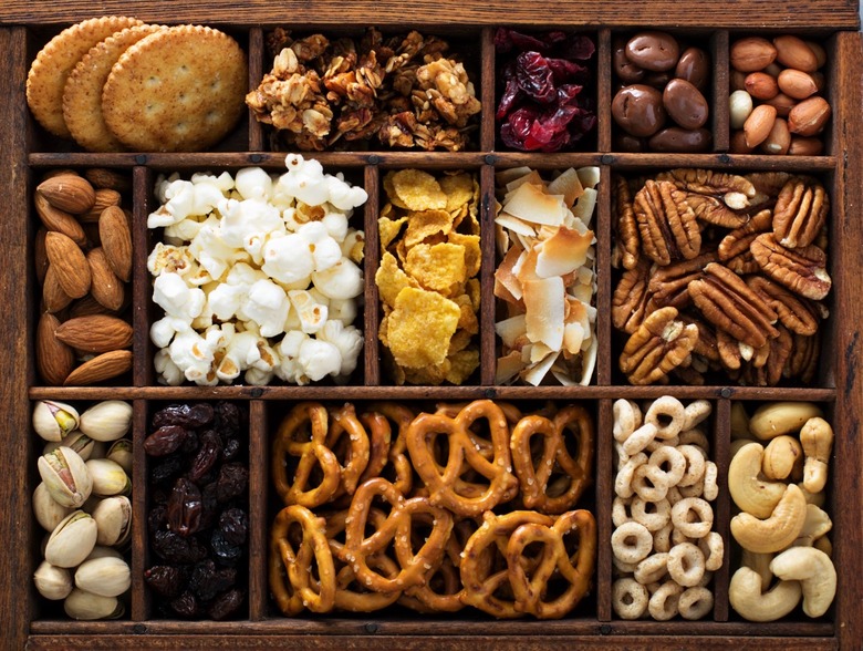 Variety of healthy snacks, overhead shot in a wooden box.