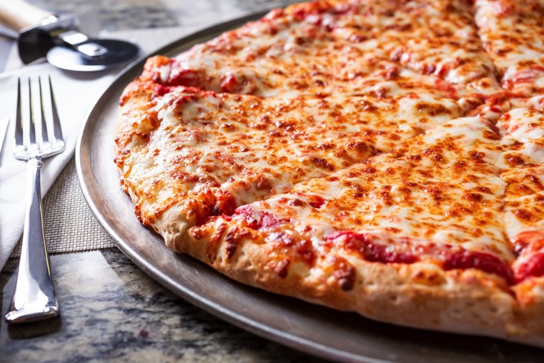 A closeup view of a plain cheese pizza pie.