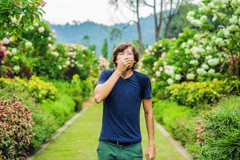 Young man suffering from seasonal allergies.