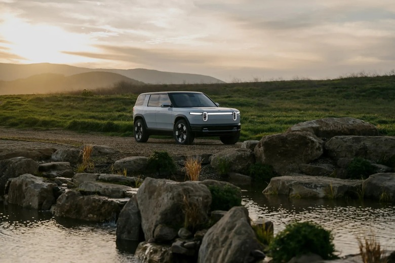 A Rivian R2 next to a river