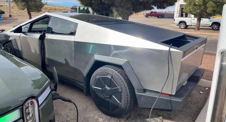 Tesla Cybertruck charging a Rivian