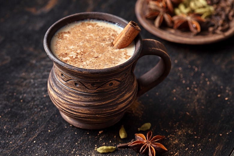 Masala pulled tea chai latte in rustic clay cup.