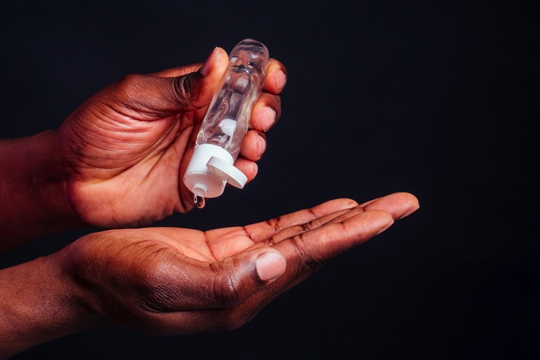 A person using hand sanitizer
