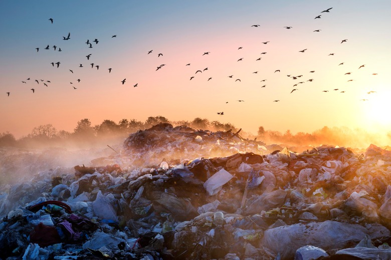 garbage in a landfill with methane emissions over it