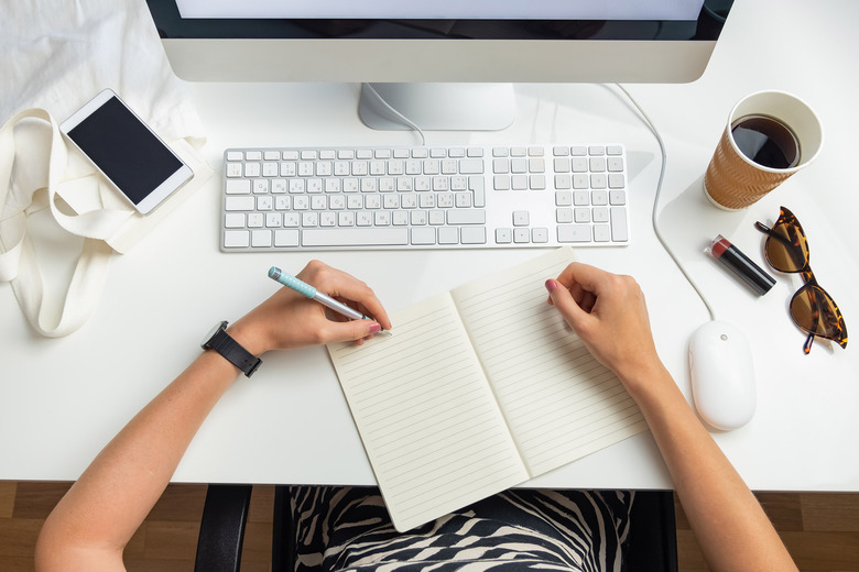 top-view of left-handed businesswoman in work environment