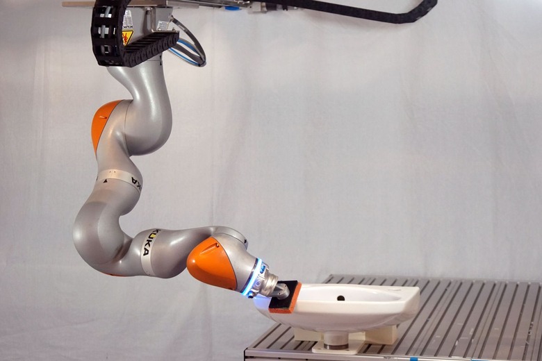 self-learning robotic arm cleaning a sink