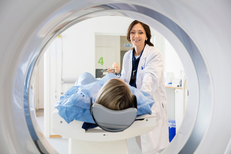 doctor talking to patient getting medical scan
