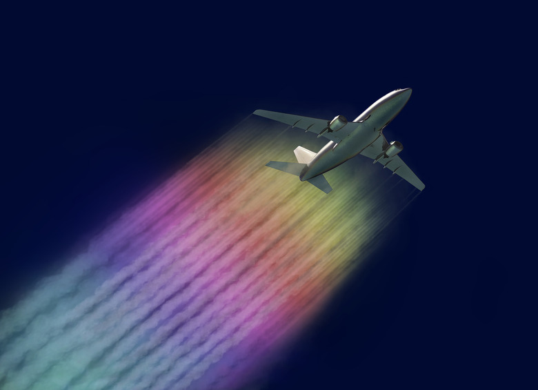 rainbow contrails behind airplane