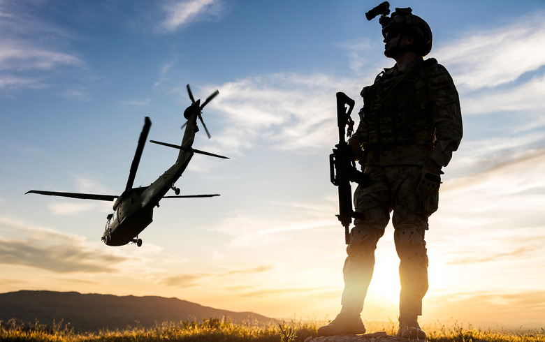 A solider stands in the desert heat