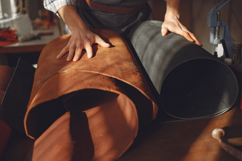 man holding folds of leather
