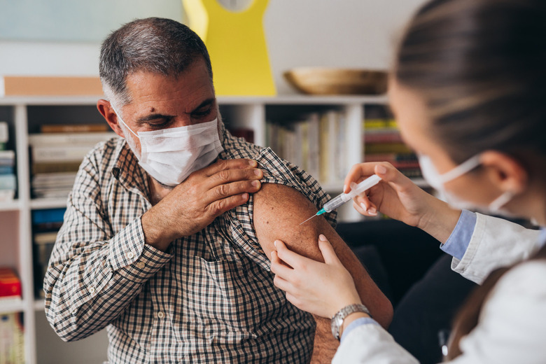 nurse gives man vaccine shot