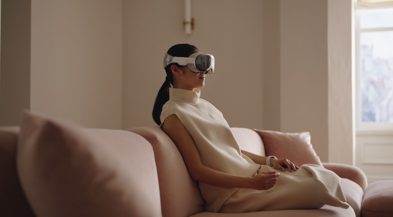A person using the Vision Pro mixed-reality headset at home.