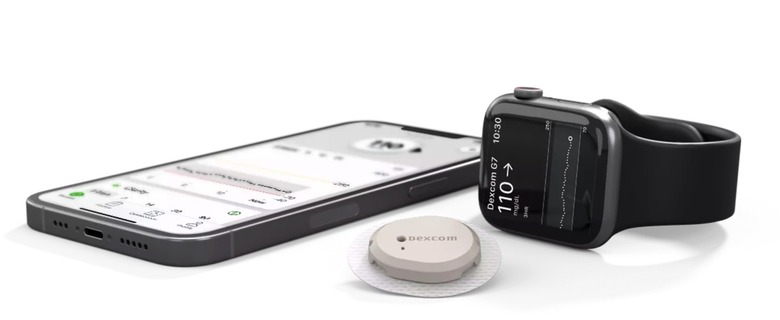 Dexcom G7 CGM device between the iPhone and Apple Watch.