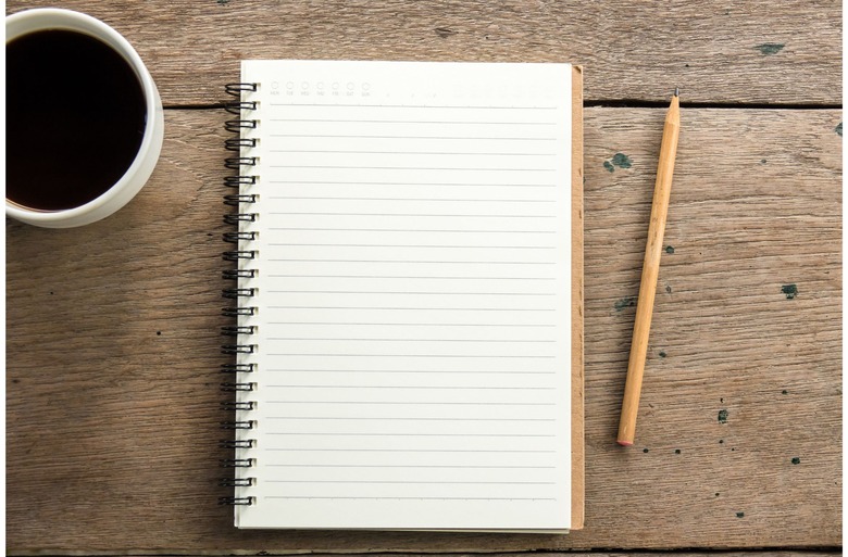 notebook on table with coffee
