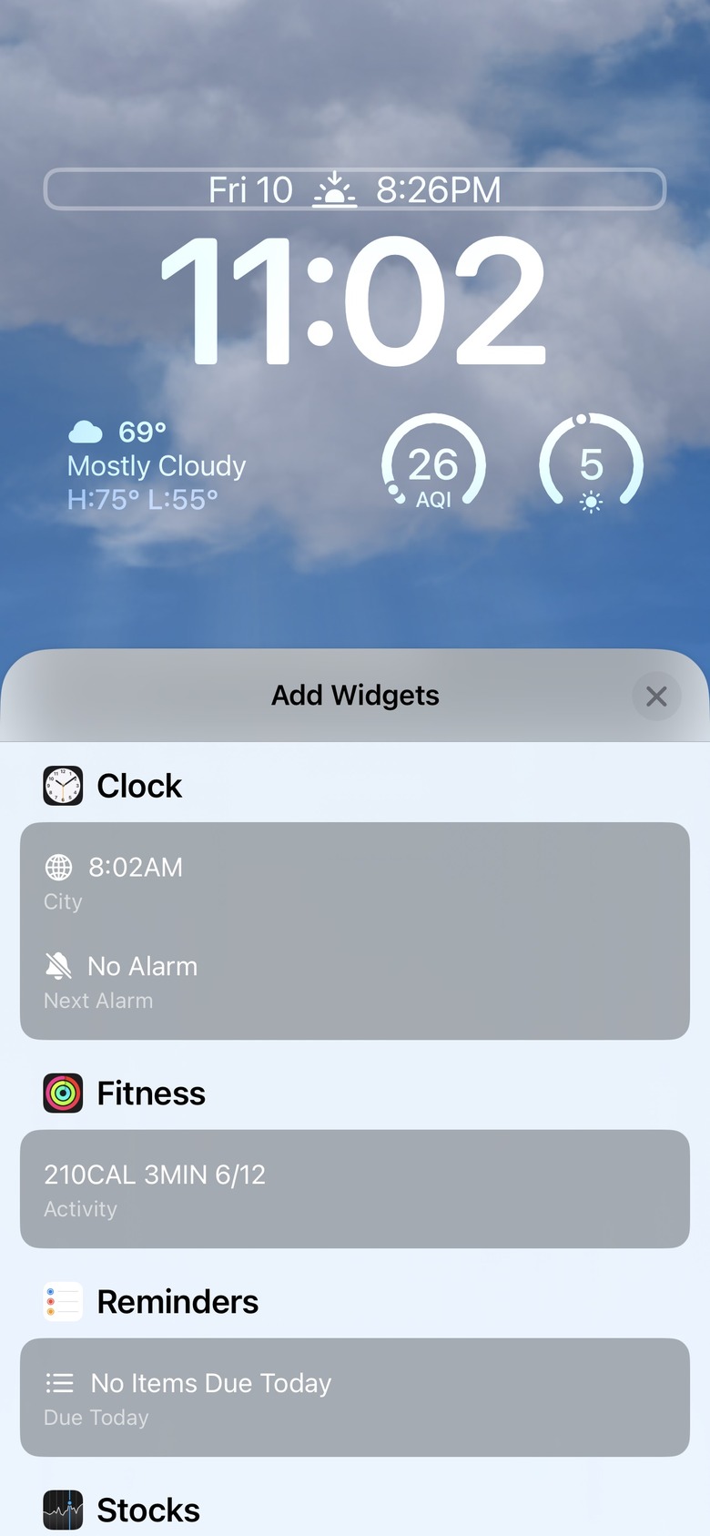 iOS 16 widgets above the clock.