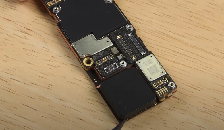 iPhone 14 Pro Max logic board and location of the plastic piece.