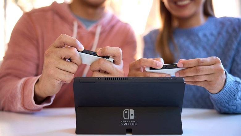 Two people playing on the new Nintendo Switch (OLED) model