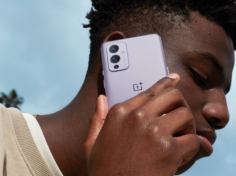 A person using the OnePlus 9 phone