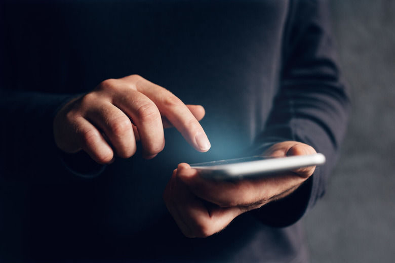 hand tapping smartphone screen