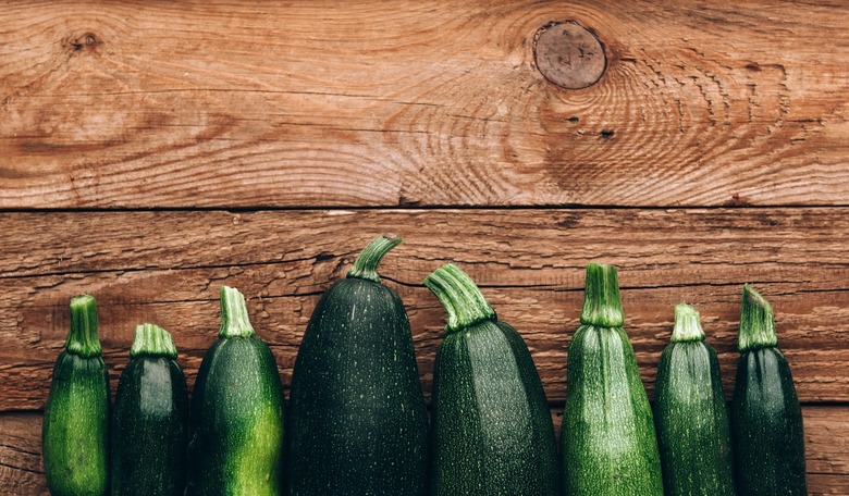 Fresh farmer organic zucchini on a wooden background