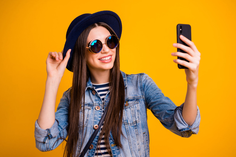 influencer female taking iphone photo