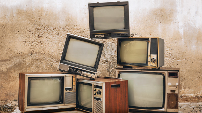 A pile of old CRT televisions