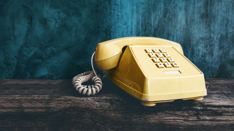 vintage 80s phone with a cord and a dial pad