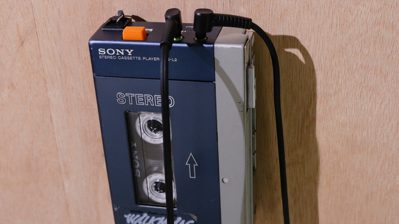 Close up of the original Sony walkman with headphone cables plugged in