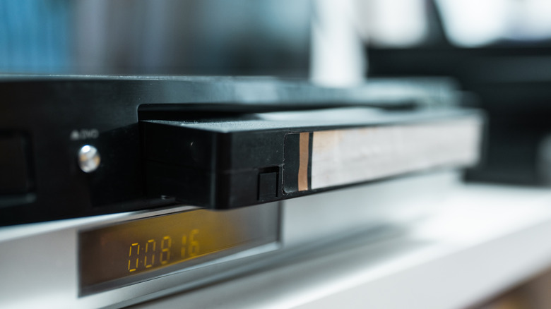 Close up of a VCR holding a VHS tape