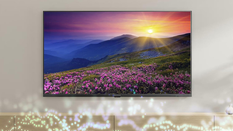 A Fire TV-powered TV from Insignia mounted on an off-white wall.