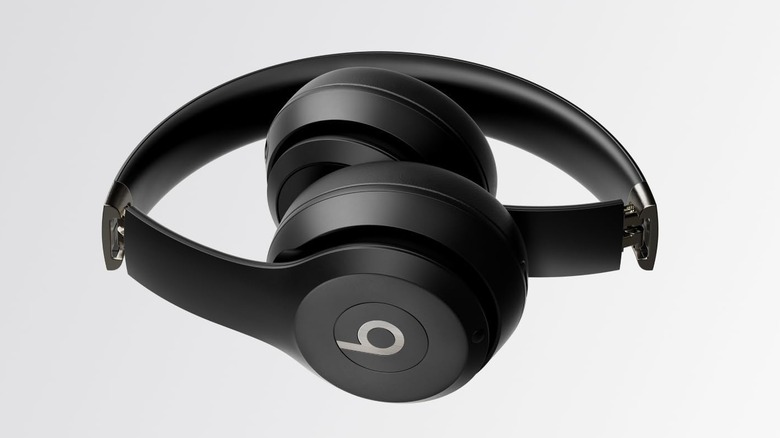 Beats Solo 4 wireless headphones folded on grey background