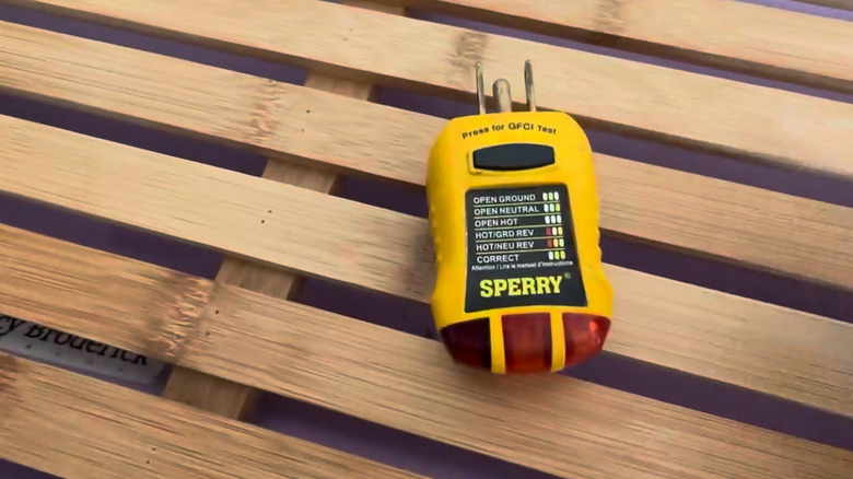 Sperry outlet tester on wooden slats
