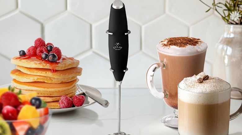 Zulay Milk Frother surrounded by coffees and breakfast food