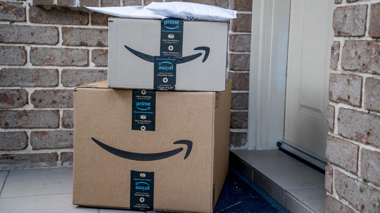 Amazon boxes placed outside a door.