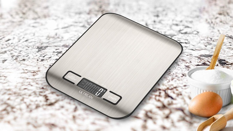 The Ultrean food scale on a kitchen counter with some ingredients.