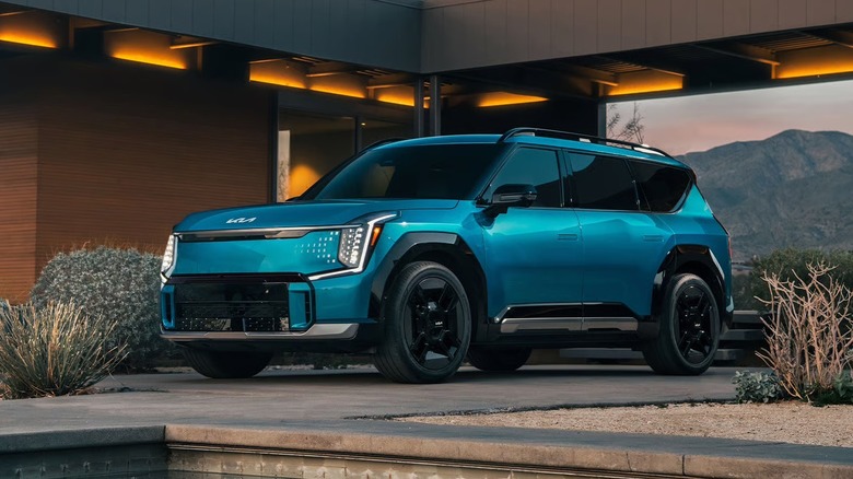 Kia EV9 parked inside a futuristic house out in the countryside