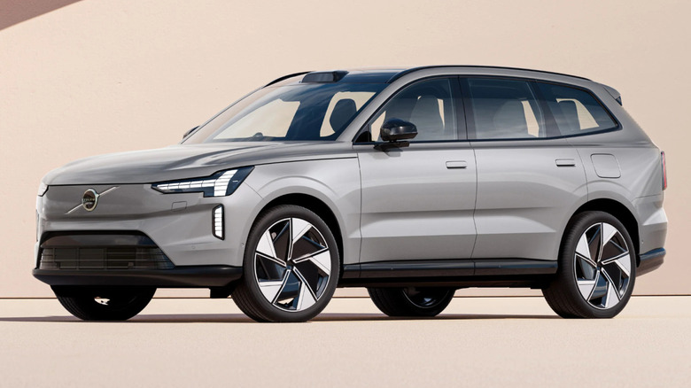 Volvo EX90 parked against a pink backdrop