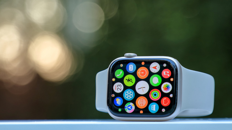 An Apple Watch on its side, showing apps on its screen.