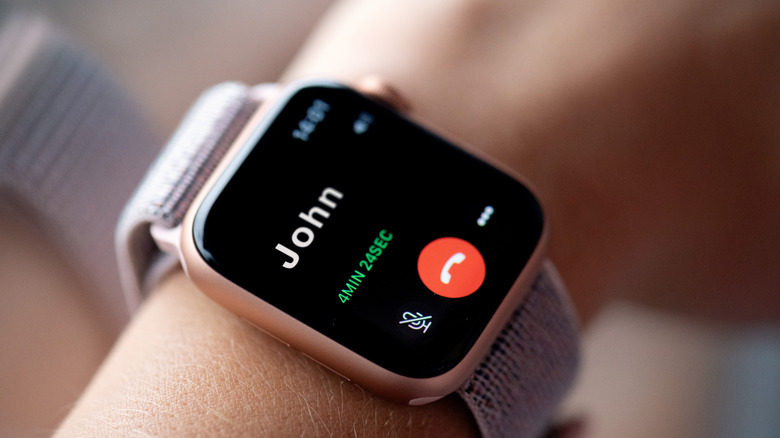 A person using an Apple Watch to make a call.