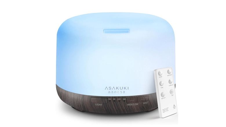 Asakuki Diffuser with a blue light on and the remote leaning against it