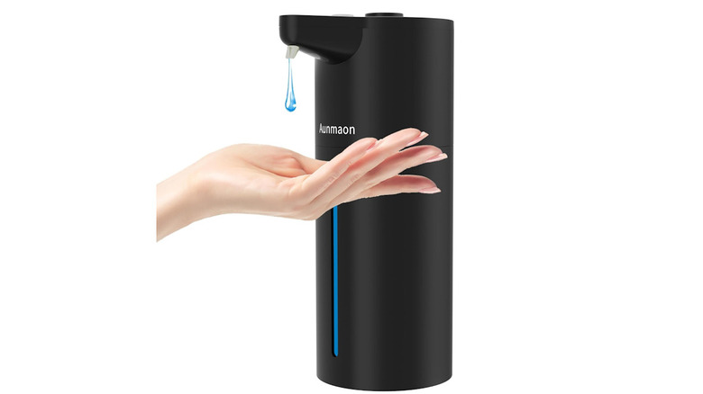 Aunmaon soap dispenser with hand underneath the nozzle