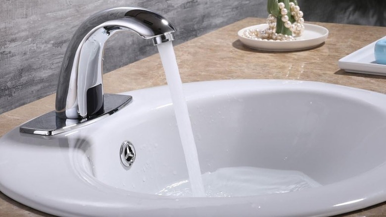 The Charmingwater faucet running into the sink