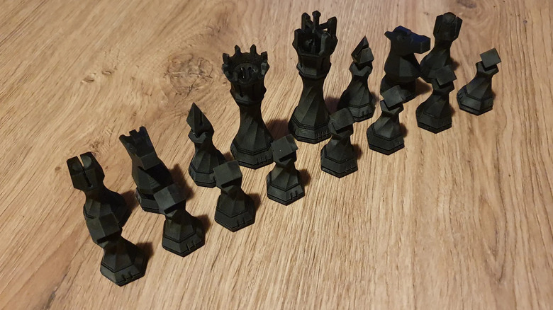 Black chess pieces on a wooden table